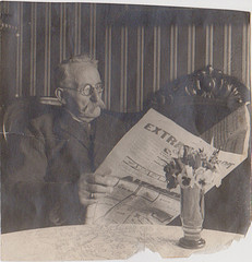 old man reading paper