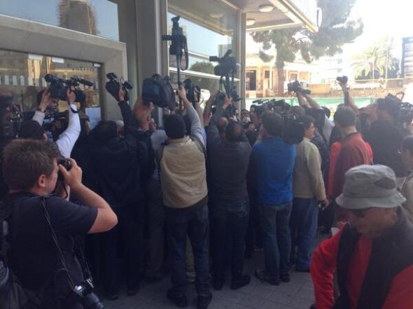 Banks reopen in Cyprus and media jostle to get the best view - posted by Joe Parkinson (@JoeWSJ)