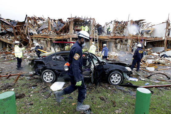 Firefighter conduct search and rescue of an apartment destroyed by an explosion at a fertilizer plant in West, Texas, Thursday, April 18, 2013. 