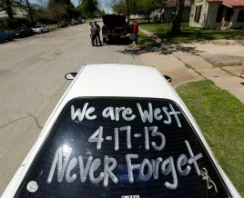 A sign is seen on a car window as residents wait to enter a damaged neighborhood Saturday, April 20, 2013, three days after an explosion at a fertilizer plant in West, Texas (Houston Chronicle)