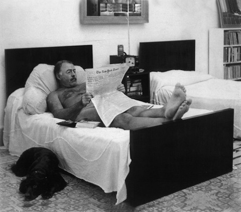 Ernest Hemingway reading The New York Times (naked)