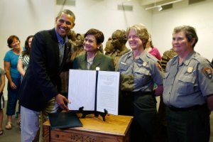 U.S. President Barack Obama hands a copy of the speech that he gave before signing the Lilly Ledbetter Fair Pay Restoration Act in Waterloo at women in Seneca Falls