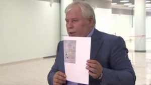 Lawyer Anatoly Kucherena holds Edward Snowden's entry papers from Russian Immigration Service