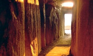 Sun coming up the passage during the winter solstice at Newgrange Tomb. Photograph: National Monuments Service