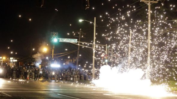 August 13, 2014: A device deployed by police goes off in the street as police and protesters clash in Ferguson, Mo. (AP Photo/Jeff Roberson)