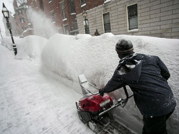 City worker tries to clear a sidewalk in downtown Boston