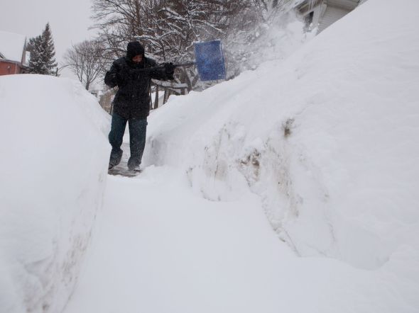 Man shoveling in Dorchester neighborhood, Feb. 9, 2015