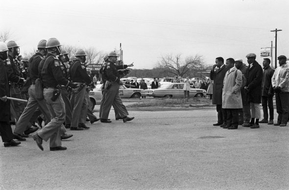 Two Minute Warning, photo by Spider Martin.  Selma "marchers facing a line of state troopers in Selma moments before police beat the protestors on March 7, 1965." The day became known as Bloody Sunday. Courtesy Tracy Martin (NPR)