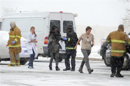 People are escorted away after a deadly shooting at a Planned Parenthood clinic Friday, Nov. 27, 2015, in Colorado Springs, Colo. A gunman opened fire at the clinic on Friday, authorities said, wounding multiple people. (Daniel Owen/The Gazette via AP)