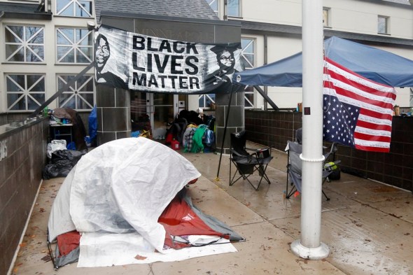 Members of Black Lives Matter continue their encampment, Tuesday, Nov. 17, 2015, outside the Minneapolis Police Department's Fourth Precinct. (AP Photo/Jim Mone)