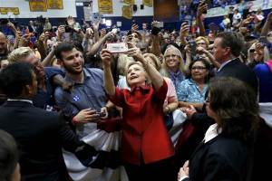 Democratic U.S. presidential candidate Hillary Clinton takes a selfie with supporters at a campaign rally at Carl Hayden Community High School in Phoenix, Arizona March 21, 2016. REUTERS/Mario Anzuoni MARIO ANZUONI / Reuters