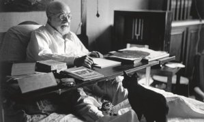 Henri Matisse working in bed, with cat