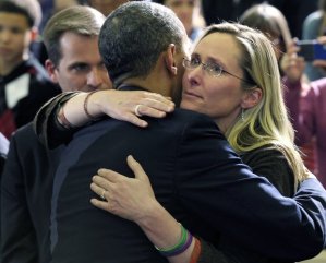  In this April 8, 2013, file photo, President Barack Obama embraces Scarlett Lewis, mother of Sandy Hook Elementary School shooting victim Jesse Lewis, after speaking at in Hartford, Conn. (AP Photo/Susan Walsh, File) (Susan Walsh)