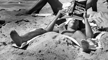 a-college-student-lays-on-fort-lauderdale-beach-while-reading-chesapeake-by-james-a-michener-march-17-1979