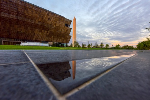 The first direct morning sun paints the Washington Monument a shade of red near the Smithsonian Institute''s National Museum of African American History and Culture in Washington, DC. MUST CREDIT: Washington Post photo by Jahi Chikwendiu