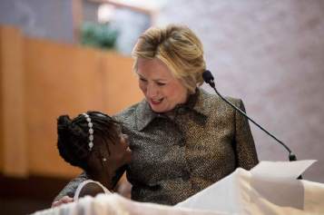 Democratic presidential candidate Hillary Clinton speaks with Zianna Oliphant onstage after speaking at the Little Rock AME Zion Church in Charlotte, N.C., Sunday, Oct. 2, 2016. (AP Photo/Andrew Harnik)