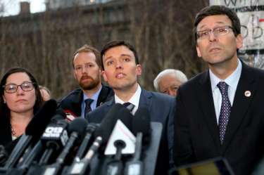 Solicitor General Noah Purcell (C) and Washington state Attorney General Bob Ferguson (R) speak at a press conference outside U.S. District Court, Western Washington, on Feb. 3, 2017
