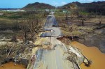 A bicyclist rides down a damaged road in Toa Alta, west of San Juan, Puerto Rico.RICARDO ARDUENGO AFP GETTY&nbsp;IMAGES