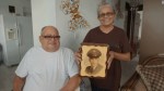 Miguel Olivera and his wife Diana Aponte show a picture from his time in&nbsp;service.
