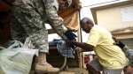 National Guard personnel evacuate Toa Ville resident Luis Alberto Martinez after the passing of Hurricane Maria, in Toa Baja, Puerto Rico, Friday, September 22,&nbsp;2017.
