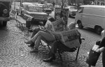 People reading the newspaper on a bench in the street after the American moon landing, The Netherlands, July 21,&nbsp;1969