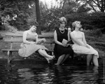 Three women keep cool during a heat wave by moving a park bench into the water in Central Park, New York,&nbsp;1961