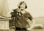 Woman holding young cat, likely&nbsp;1920s