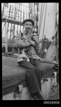 Seaman with a cat and kitten, c 1910, Australian Maritime Museum