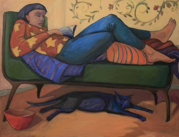 Woman reading with large cat under the couch