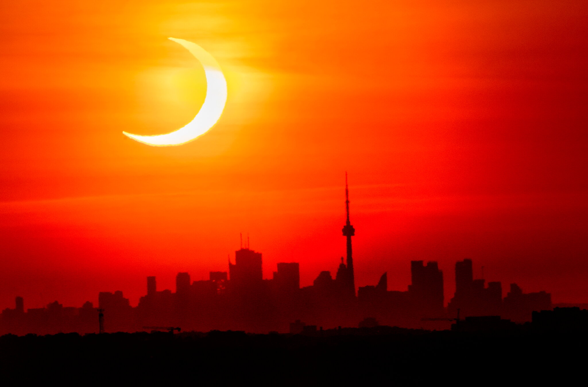 Thursday’s eclipse over the Toronto skyline.Credit Frank Gunn, The Canadian Press, via Associated Press
