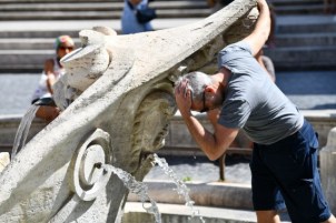 People cool off in fountains in Rome to deal with the heat.