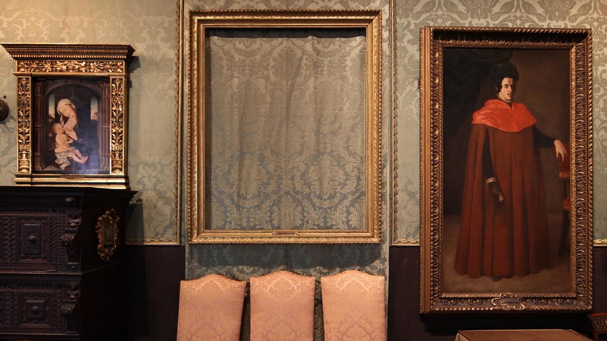 Empty frame hangs where a painting was stolen